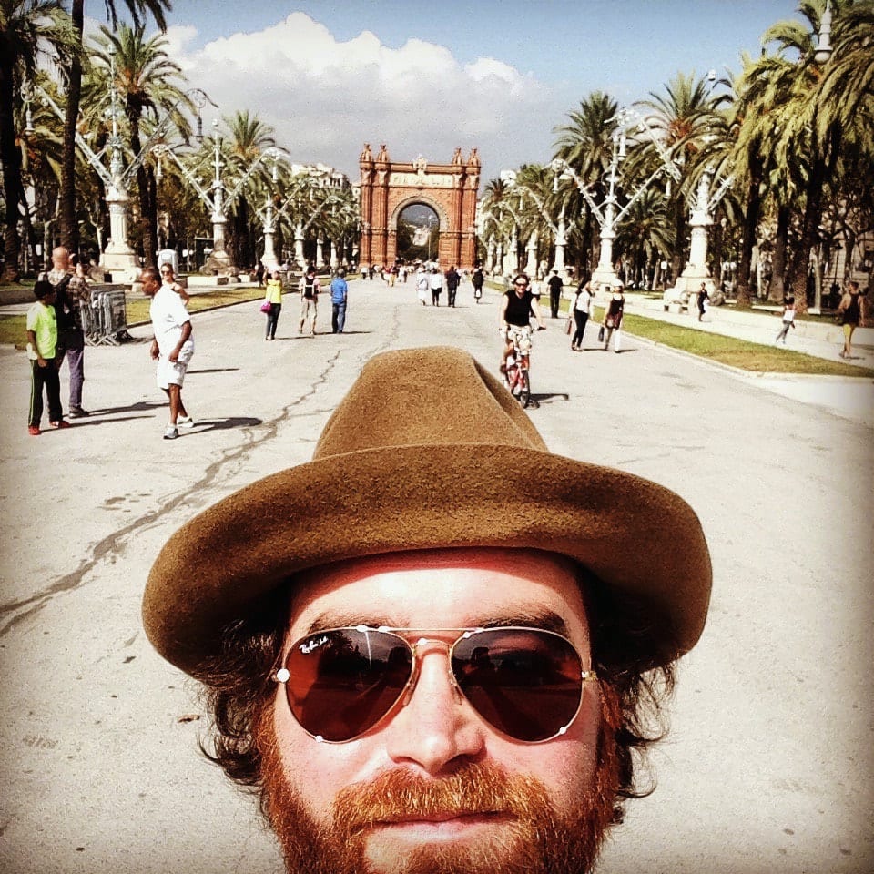 The founding guitarist taking a close self-portrait on the palm-lined approach to Barcelona's Arc de Triomf.