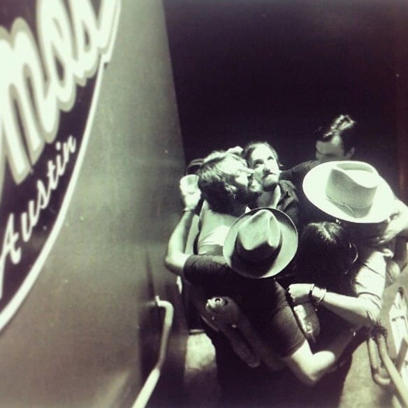Several unidentified Wild Feathers members and associates embracing in a backstage huddle at Emo’s in Austin.