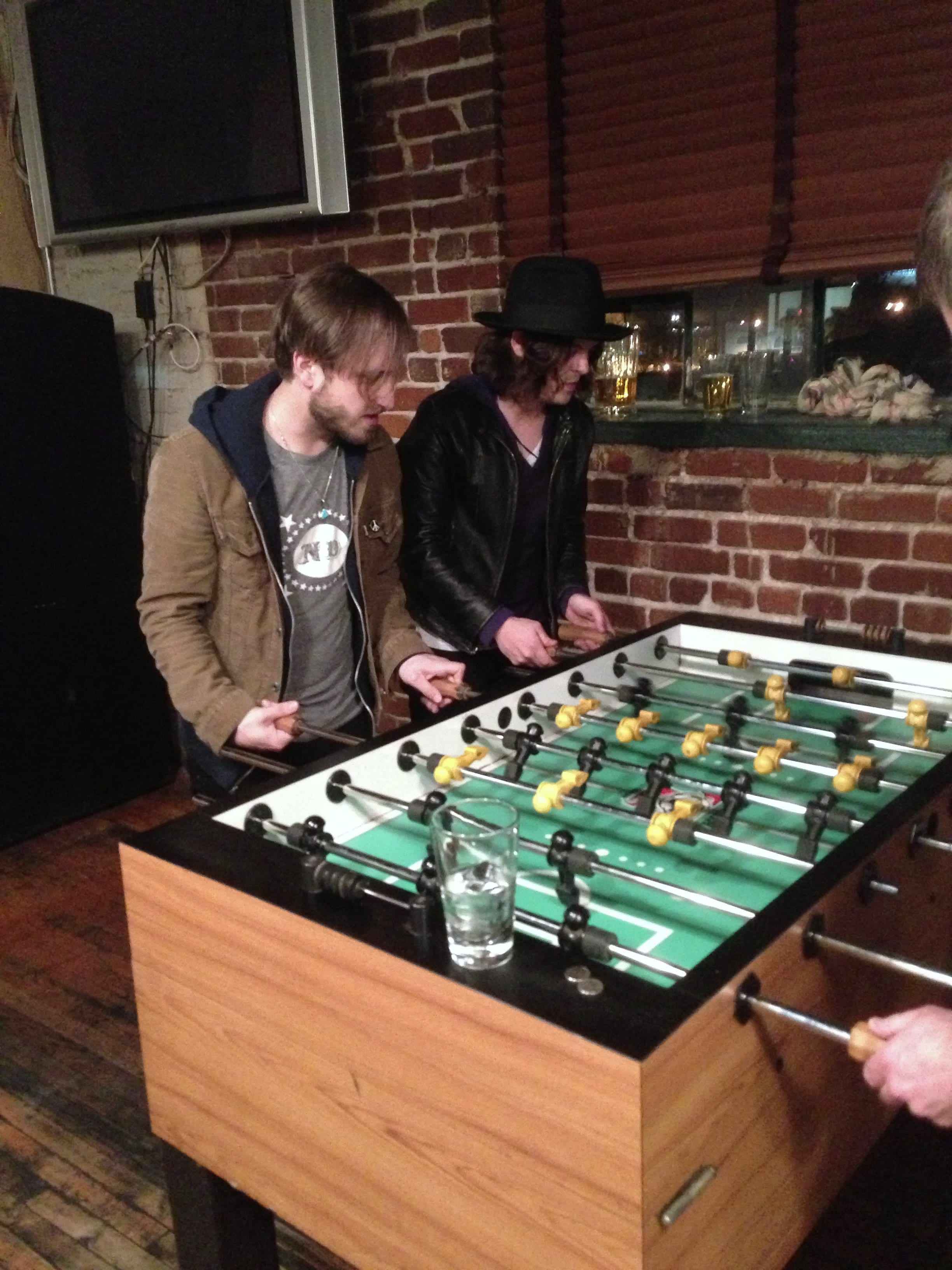 Two members of The Wild Feathers playing foosball at Barley's Taproom in Knoxville.