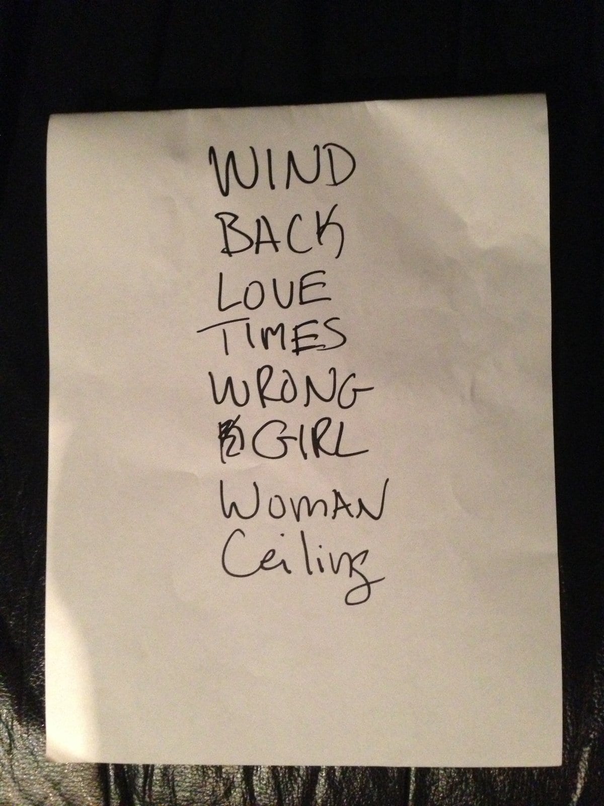 A handwritten Wild Feathers set list photographed in Charlotte, including Wind, Backwoods, Love and Times.