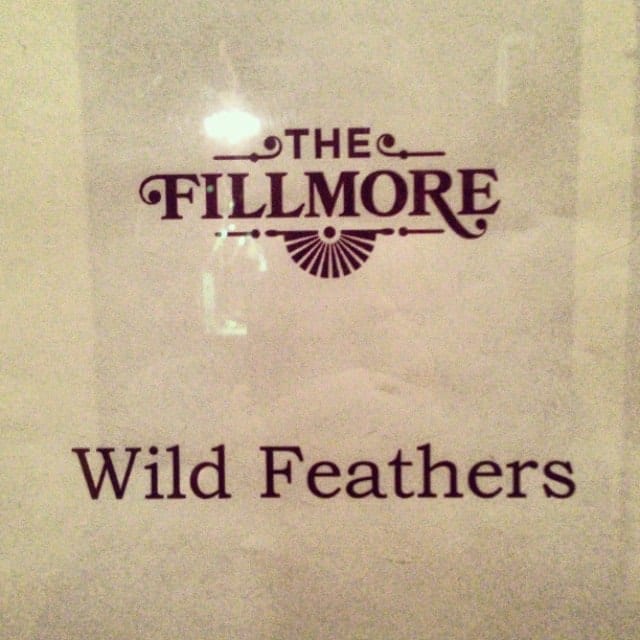 A close photograph of a venue sign reading The Fillmore and Wild Feathers.