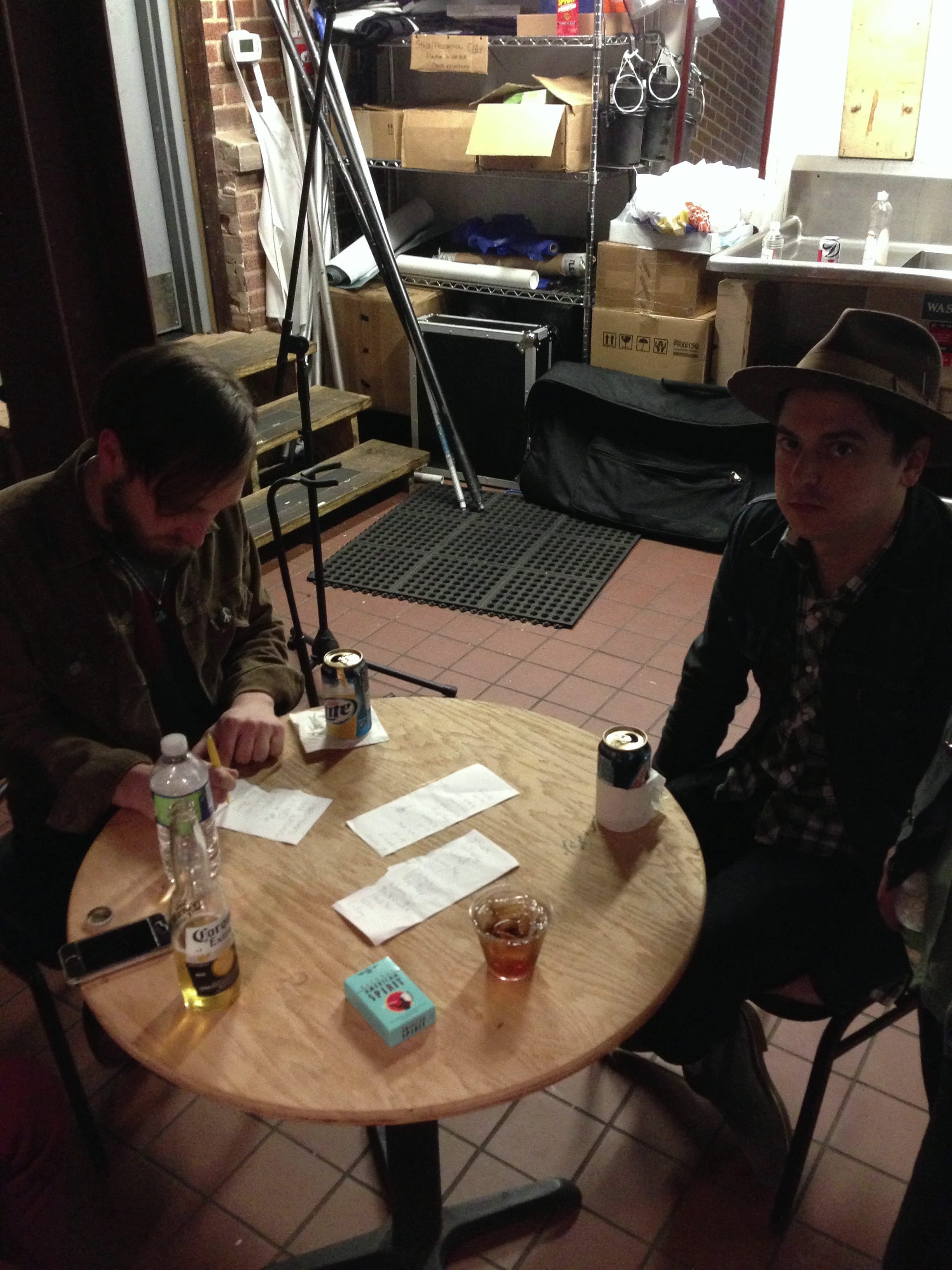 Two members of The Wild Feathers seated at a small table in Jackson, Mississippi.