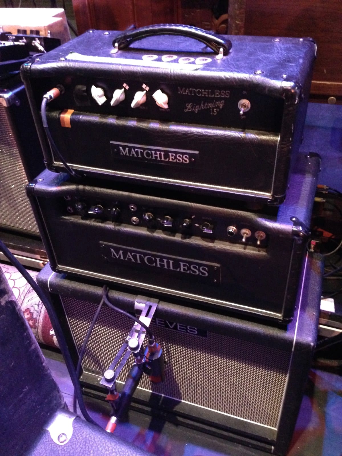 Two Matchless amplifiers stacked beside stage equipment at the Kingston tour stop.