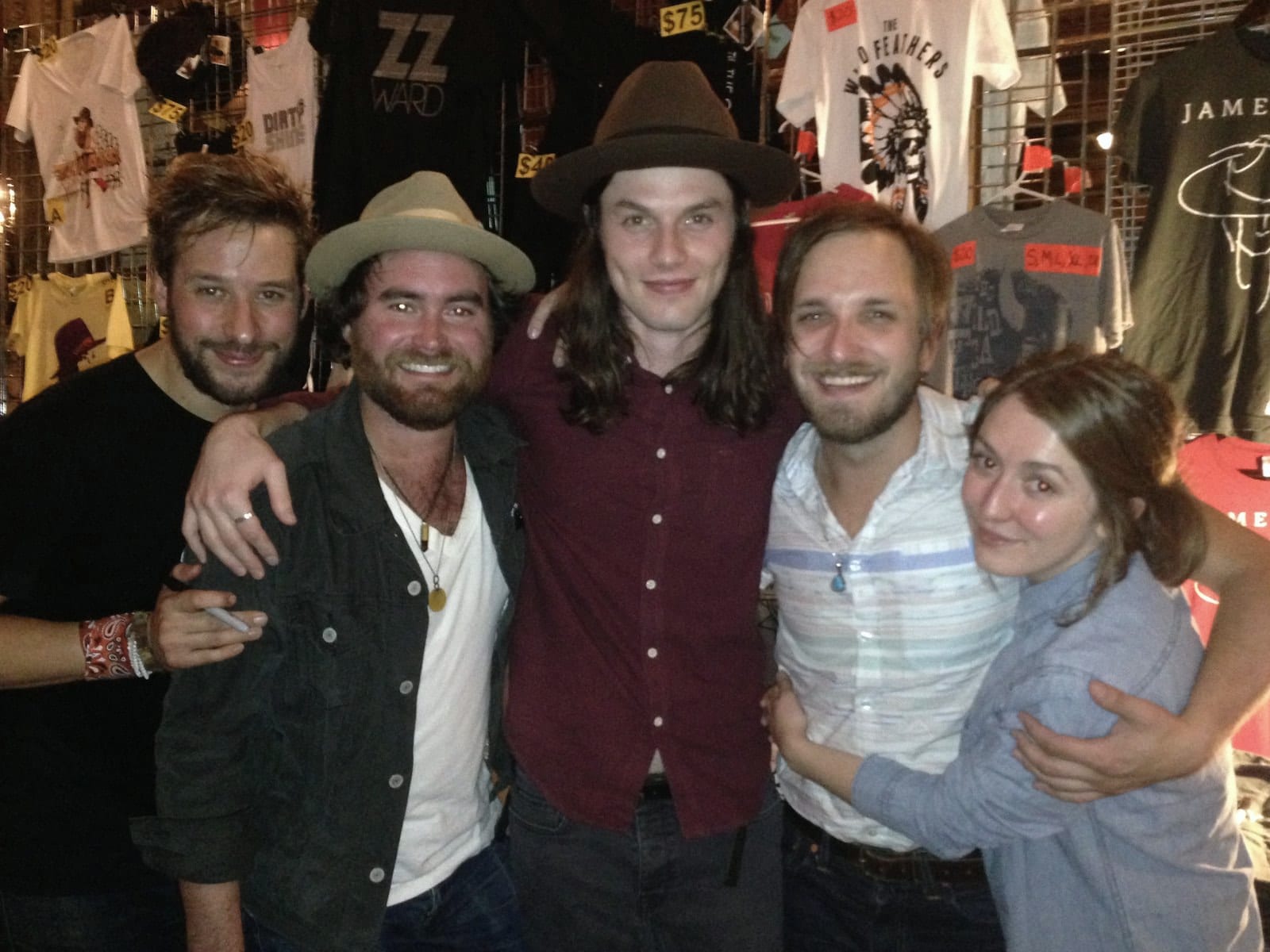 Members of The Wild Feathers and a guest posing together after the Kansas City stop.