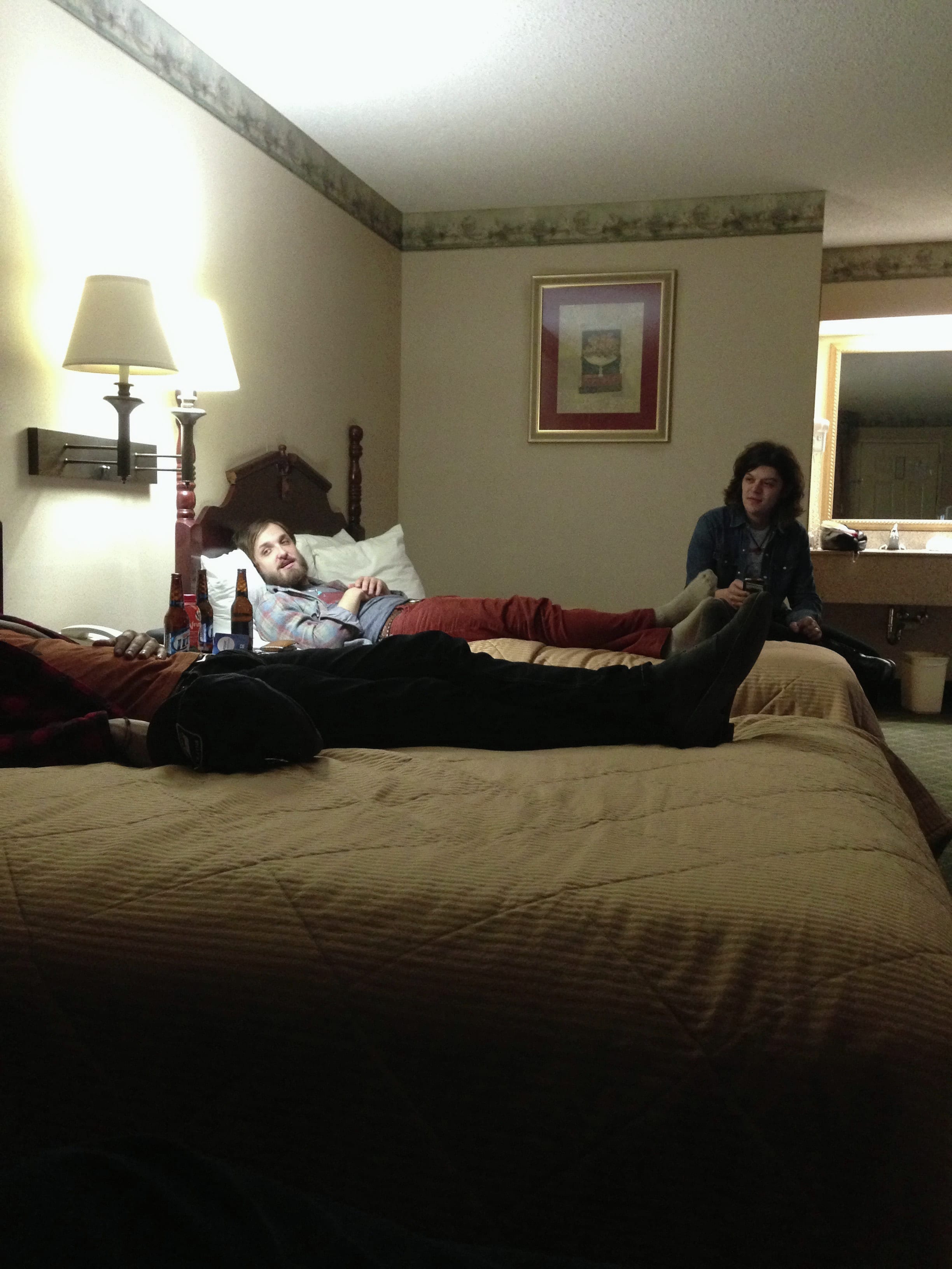 Members and companions gathered on hotel beds in Oxford, Mississippi.