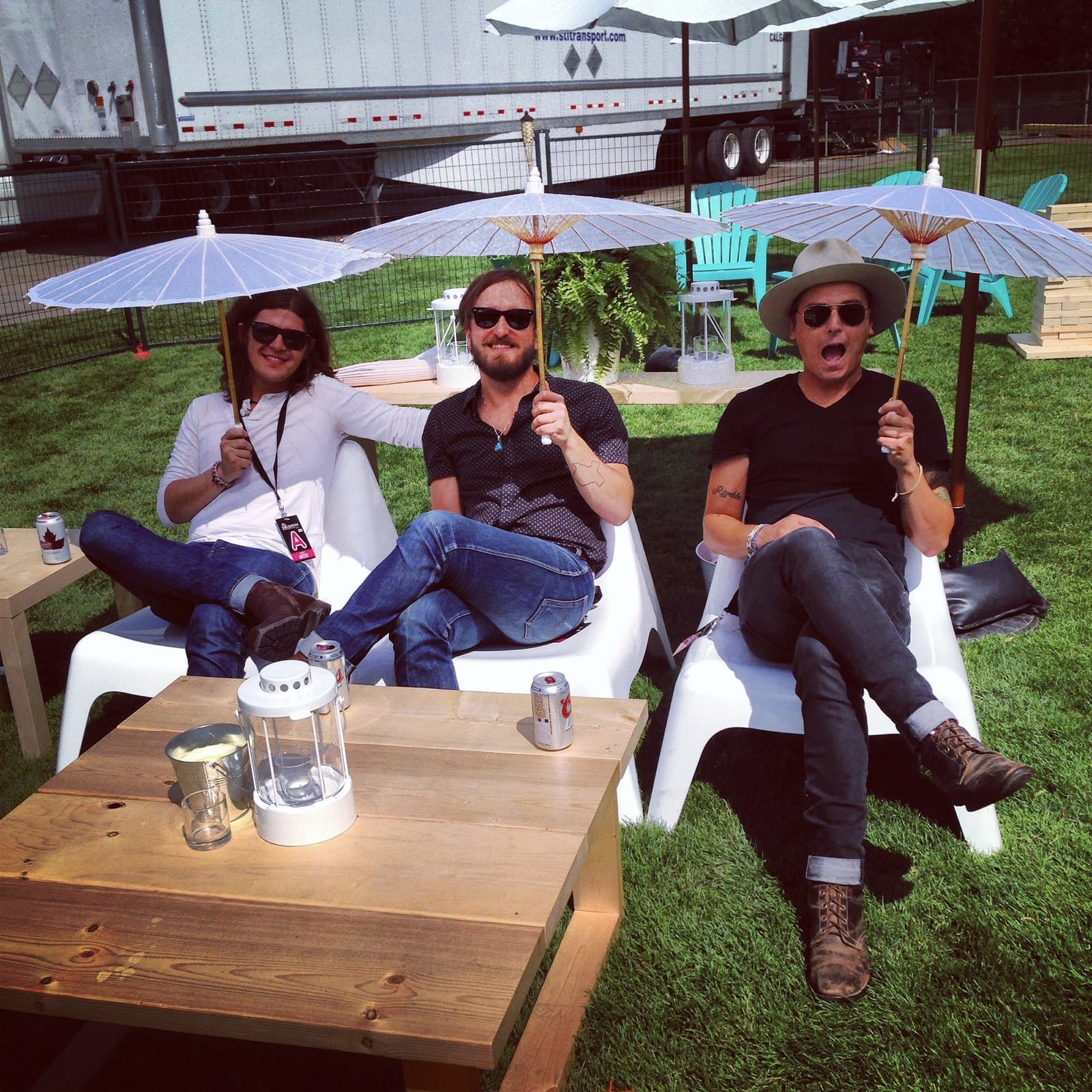 Three people relaxing in an outdoor festival lounge at the Squamish Valley Music Festival.