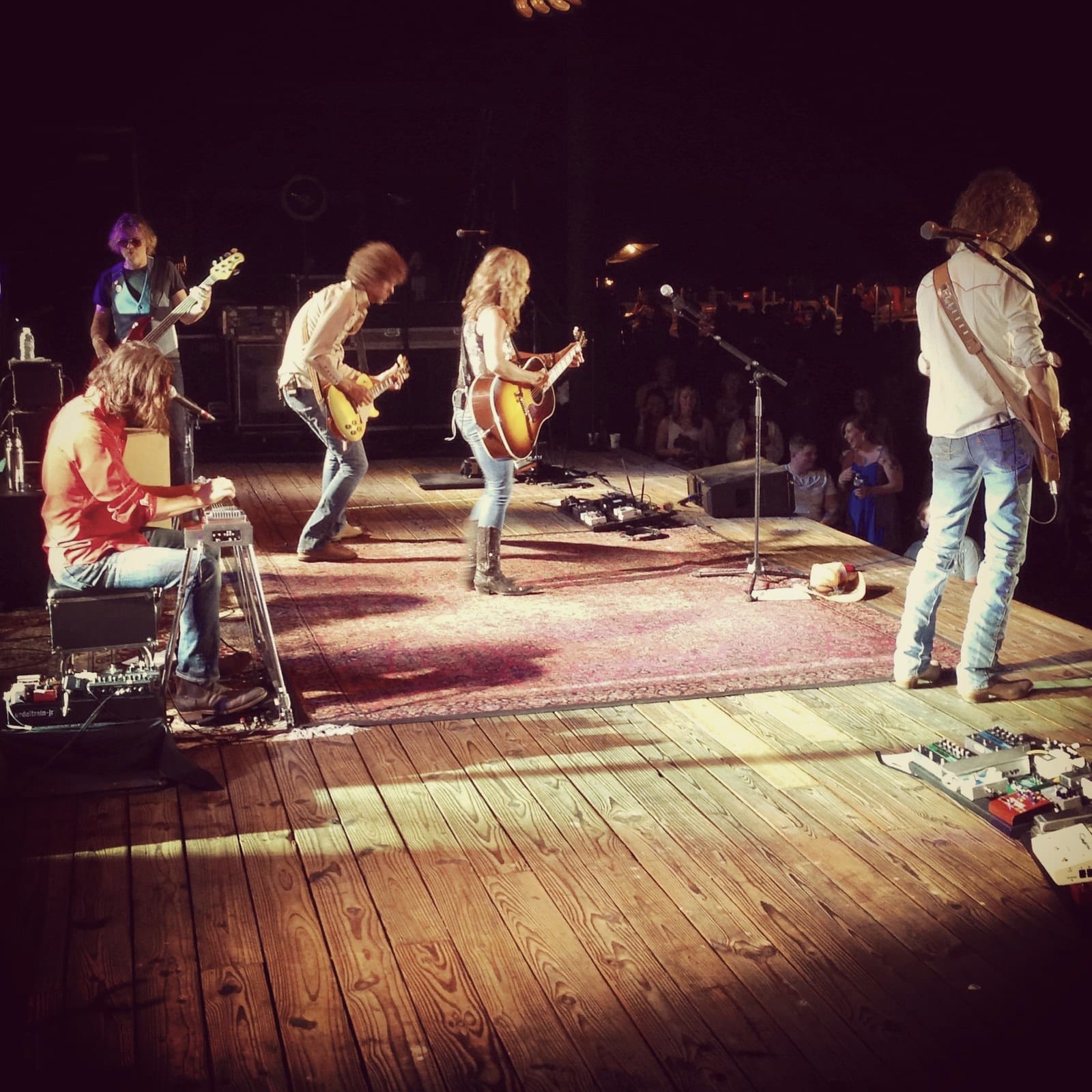 The Wild Feathers performing across a wide stage during the St. Leonard stop with Sheryl Crow.